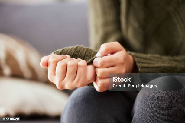 Shot Of A Unrecognizable Woman Sitting On A Sofa And Feeling Anxious Stock Photo - Download Image Now