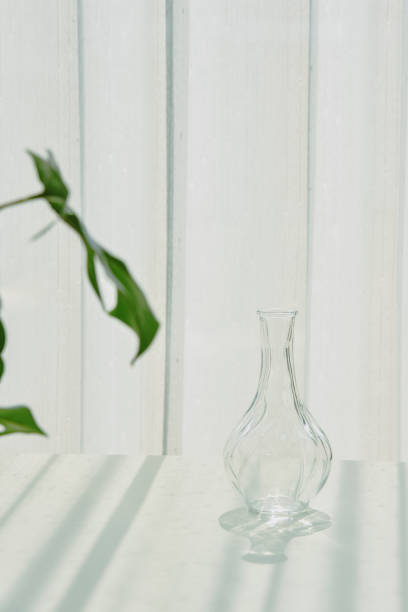 istock Glassware reflect sunlight shadow effect, Summer still life scene, Transparent glittering glasses of water, Warm light vibe in sunny day. 1388115399