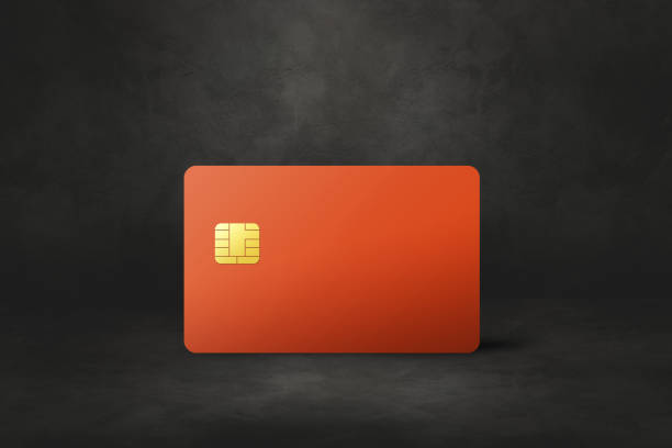 istock Orange credit card on a black concrete background 1388115553