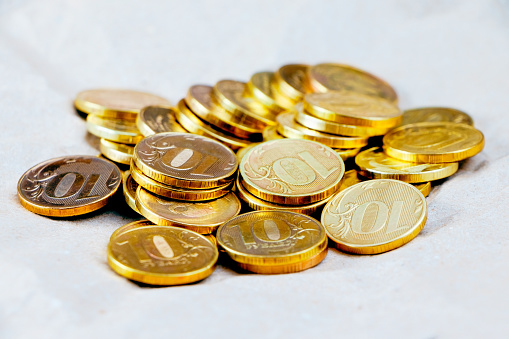 A pile of gold coins isolated on a white background. Treasure hunt. Scattered coins on the white background