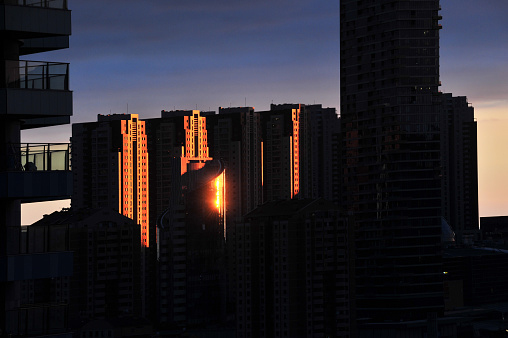 Sunlight on tall buildings at sunset