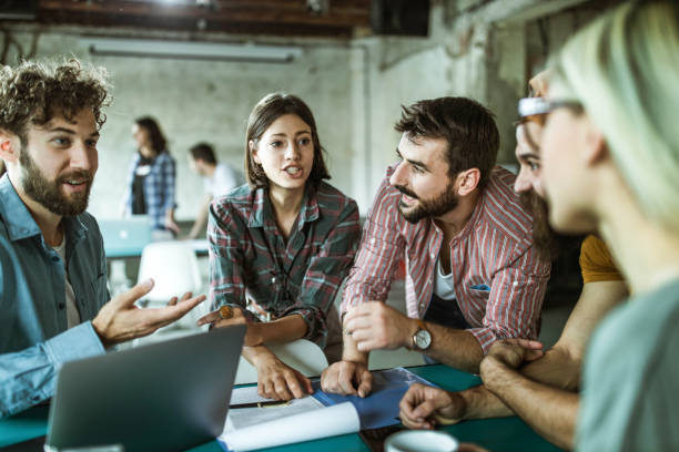 istock Happy creative team talking during a meeting at casual office. 1388121229