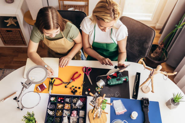 istock Mother and daughter accessories designers making handmade jewelry in studio workshop 1388121248