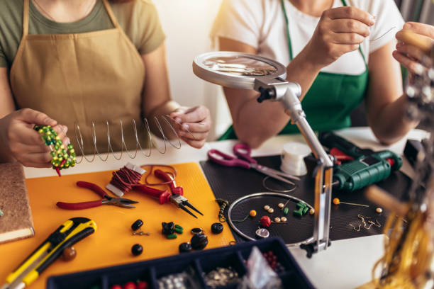 istock Mother and daughter accessories designers making handmade jewelry in studio workshop 1388121396
