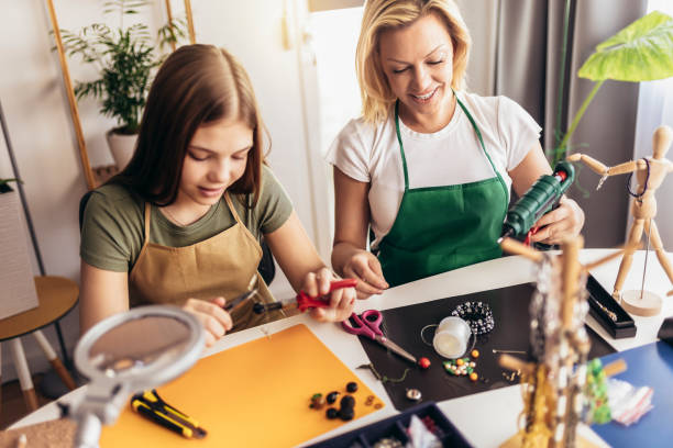 istock Mother and daughter accessories designers making handmade jewelry in studio workshop 1388122471