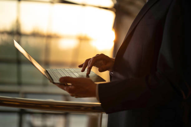 istock Close up of unrecognizable man using laptop. 1388122665