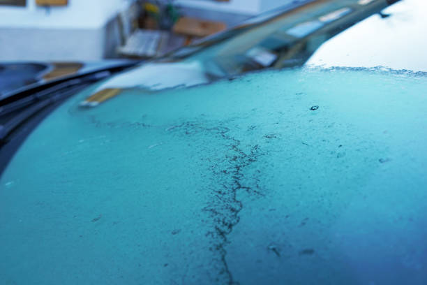 istock Close up Car windshield covered with snow ice 1388124379