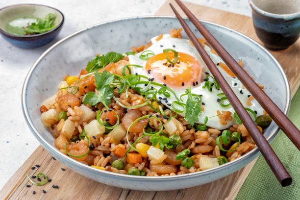 Shrimp fried rice with vegetables and egg Shrimp fried rice with vegetables and fried egg chinese cuisine fried rice asian cuisine wok stock pictures, royalty-free photos & images