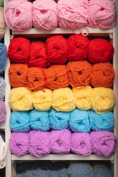istock Balls of wool in different color on the shelf 1388131125