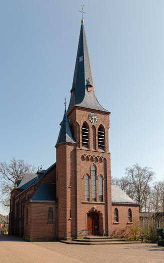 SAINTE HUBERT, BELGIUM, 3 MARCH 2022: View of the Basilica of St. Hubert and Abbey Square in the town center of St. Hubert in the Belgian Ardennes. St. Hubert is a popular tourist centre in the province of Luxembourg.