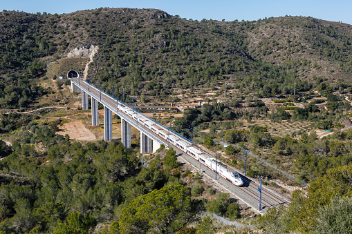 Roda de Bera, Spain - February 20, 2022: Talgo 250 high-speed train of RENFE on the Madrid - Barcelona high speed rail railway line near Roda de Bera in Spain.