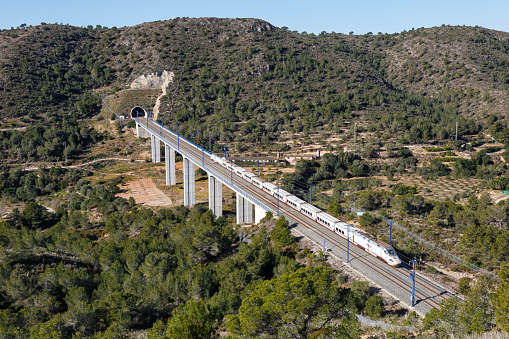 Roda de Bera, Spain - February 20, 2022: Talgo 250 high-speed train of RENFE on the Madrid - Barcelona high speed rail railway line near Roda de Bera in Spain.