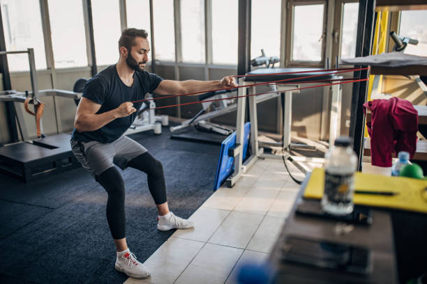 istock Man exercising in gym 1388133501