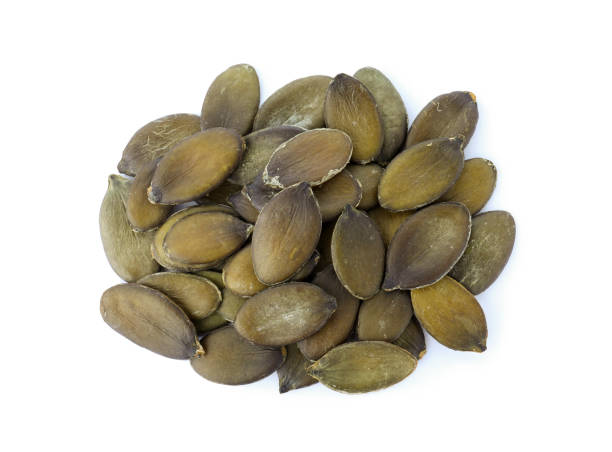 istock Peeled pumpkin seeds isolated on white, top view 1388135779