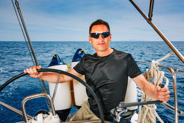 istock Confident skipper on sailboat 1388136375