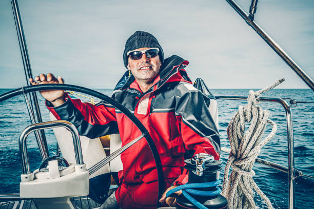 istock Happy skipper on sailboat 1388136470