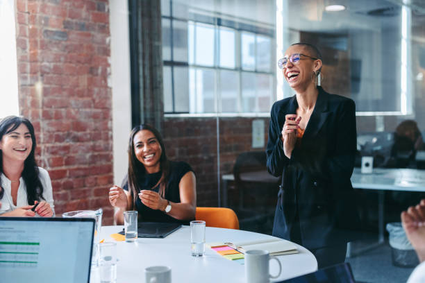 istock Creative businesswoman being applauded by her team 1388136566