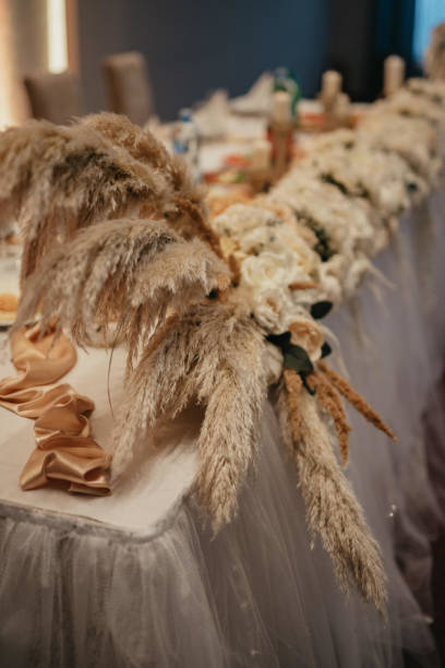 istock Decoration with fresh flowers, candles, light bulbs, garlands. Vintage style. Table setting for an event party or wedding reception. Event decorations. 1388136817