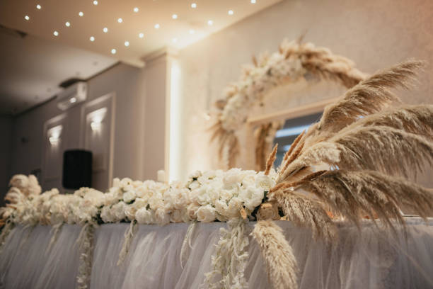 istock Decoration with fresh flowers, candles, light bulbs, garlands. Vintage style. Table setting for an event party or wedding reception. Event decorations. 1388136846