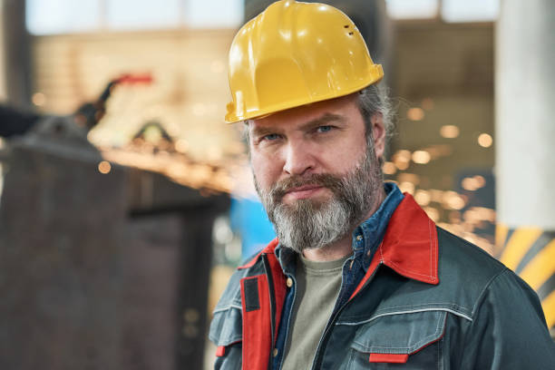 istock Man in uniform working at factory 1388138706