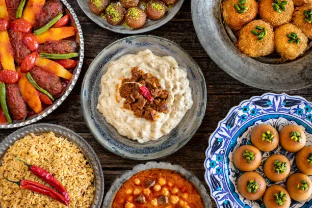 Photo of Many kinds of food on the table. Local foods named izmir köfte , hünkar beğendi and etli nohut pilav . İftar concept.