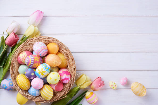 istock Happy Easter day eggs in basket and flower on wood background with copy space 1388138884