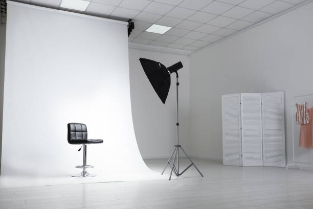 istock Photo studio interior with modern chair and professional lighting equipment 1388140421