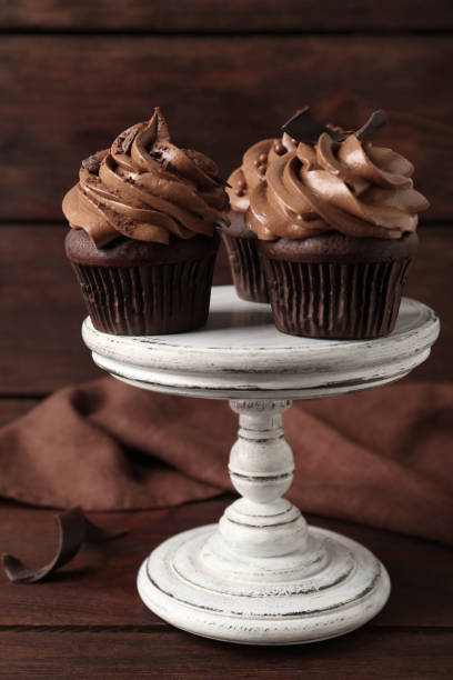 istock Delicious cupcakes decorated with cream on wooden table 1388140811