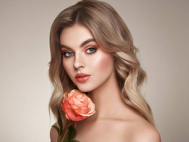 istock Beautiful young woman a rose flower 1388142083