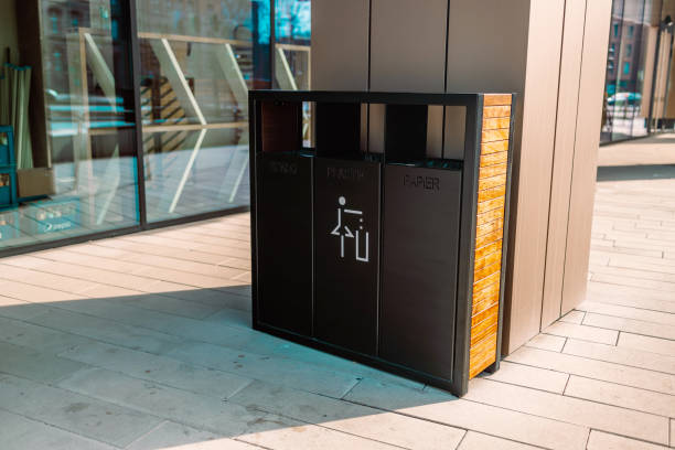 recycling and garbage concept. Modern trash container for metal, glass and plastic waste sorting on city street
