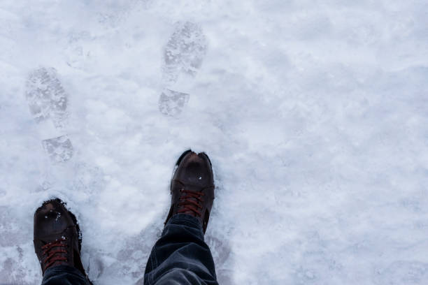 istock footprints in the snow, and the boots that own them 1388144146