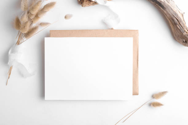 Wedding stationery invitation card mockup 7x5 on white background with envelop and boho decor