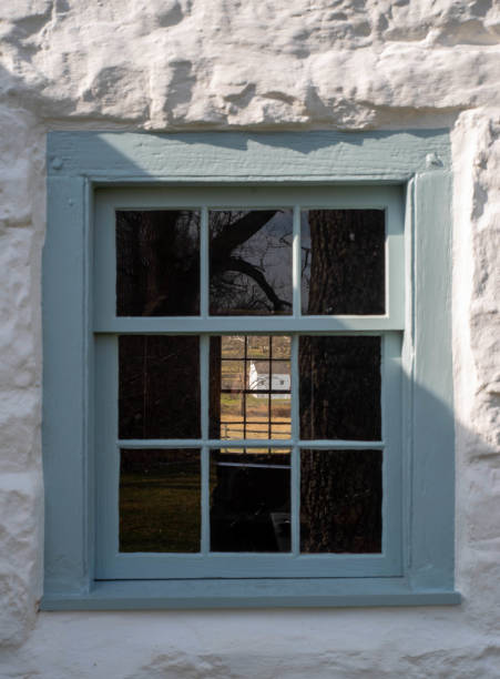 istock View through stone cottage window of rural landscape 1388148357