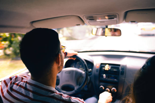 istock Young man driving around town 1388149717