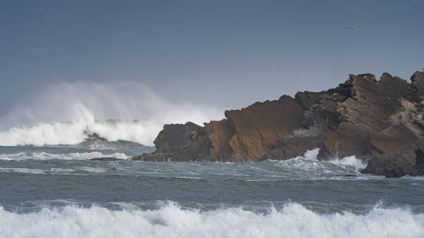 istock Rocks in the sea are covered by waves 1388149776