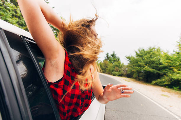 istock Girl enjoying in car drive 1388149893