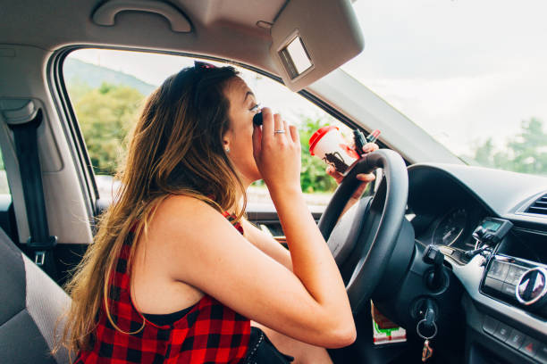 istock Reckless woman putting mascara in car 1388149977
