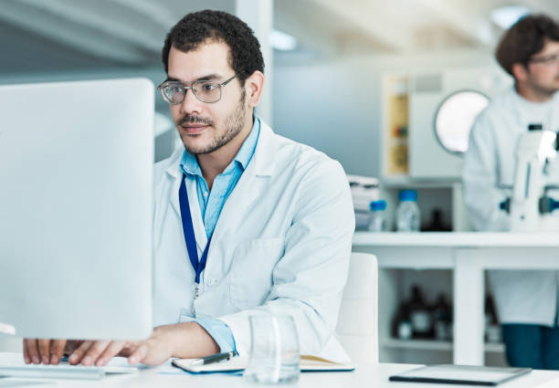 istock Shot of a young scientist working on a computer in a lab 1388150005