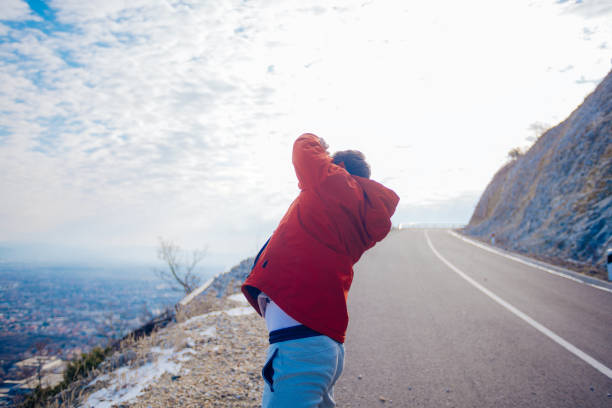 istock Fit masculine men stretching in the morning and preparing for exercise while looking at the urban city in the valley. 1388150448