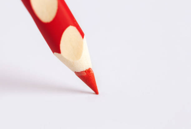 istock A red ergonomic, wooden pencil close-up stands on a white background with copy space. Selective focus on the end of the pencil. 1388150552