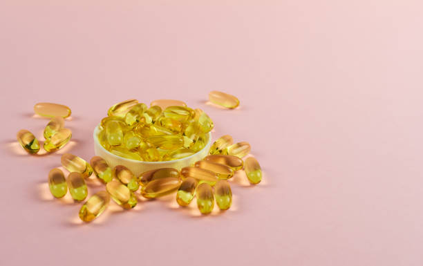 istock Fish oil on a pink background in capsules 1388150662