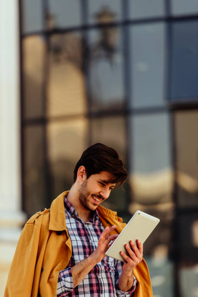 istock Modern businessman with looking on his tablet 1388150917