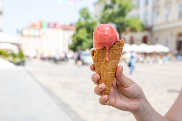 istock woman hand holding melting ice cream 1388150988