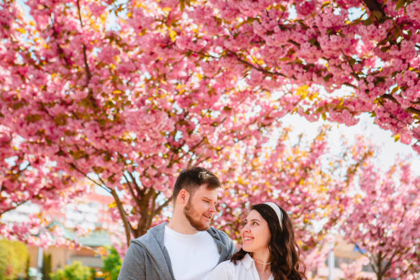istock couple lovers under blooming sakura tree 1388151095