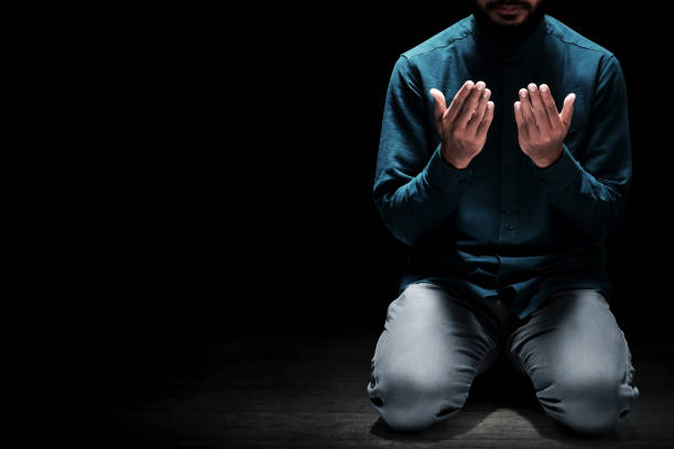 Muslim man praying in the mosque stock photo