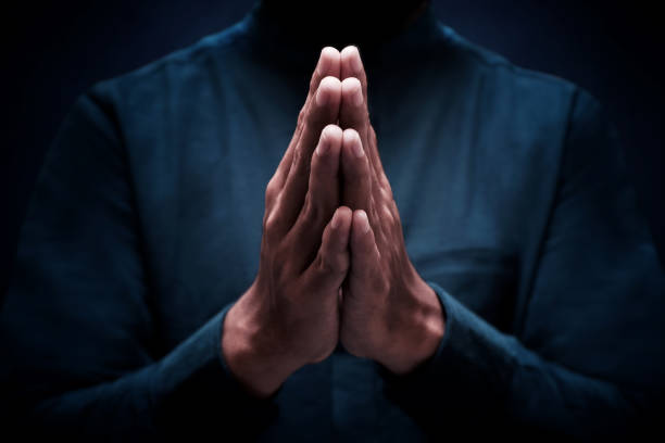 istock Muslim man greeting on dark background 1388151818