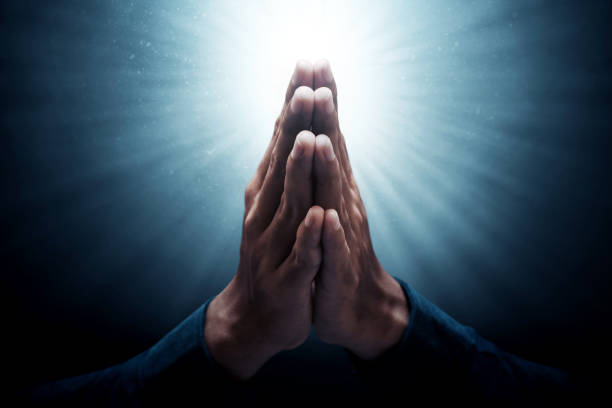 istock Muslim man greeting on dark background 1388151875