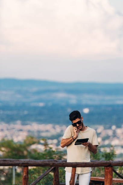 istock Man freelancer at work by table with digital tablet and laptop 1388152164
