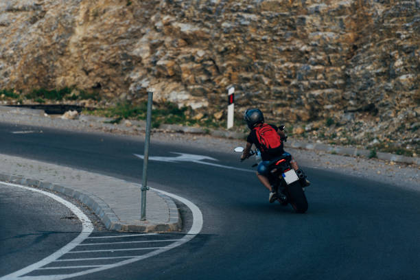 istock Man riding motorcycle in asphalt road 1388152169