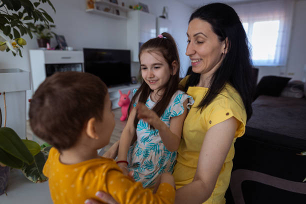 istock Woman holding her cute kids 1388152405